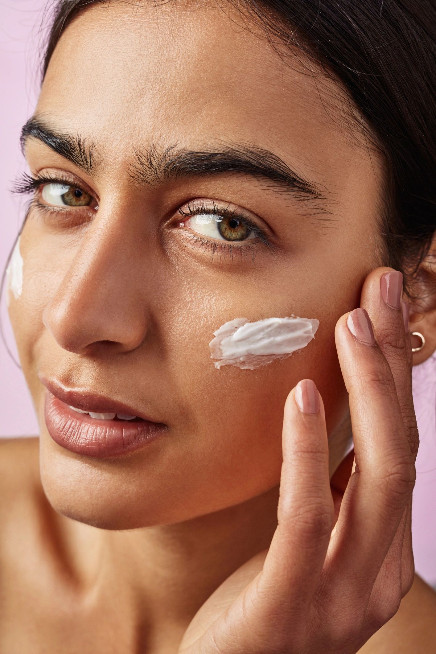 Woman applying skincare product as part of a beauty routine