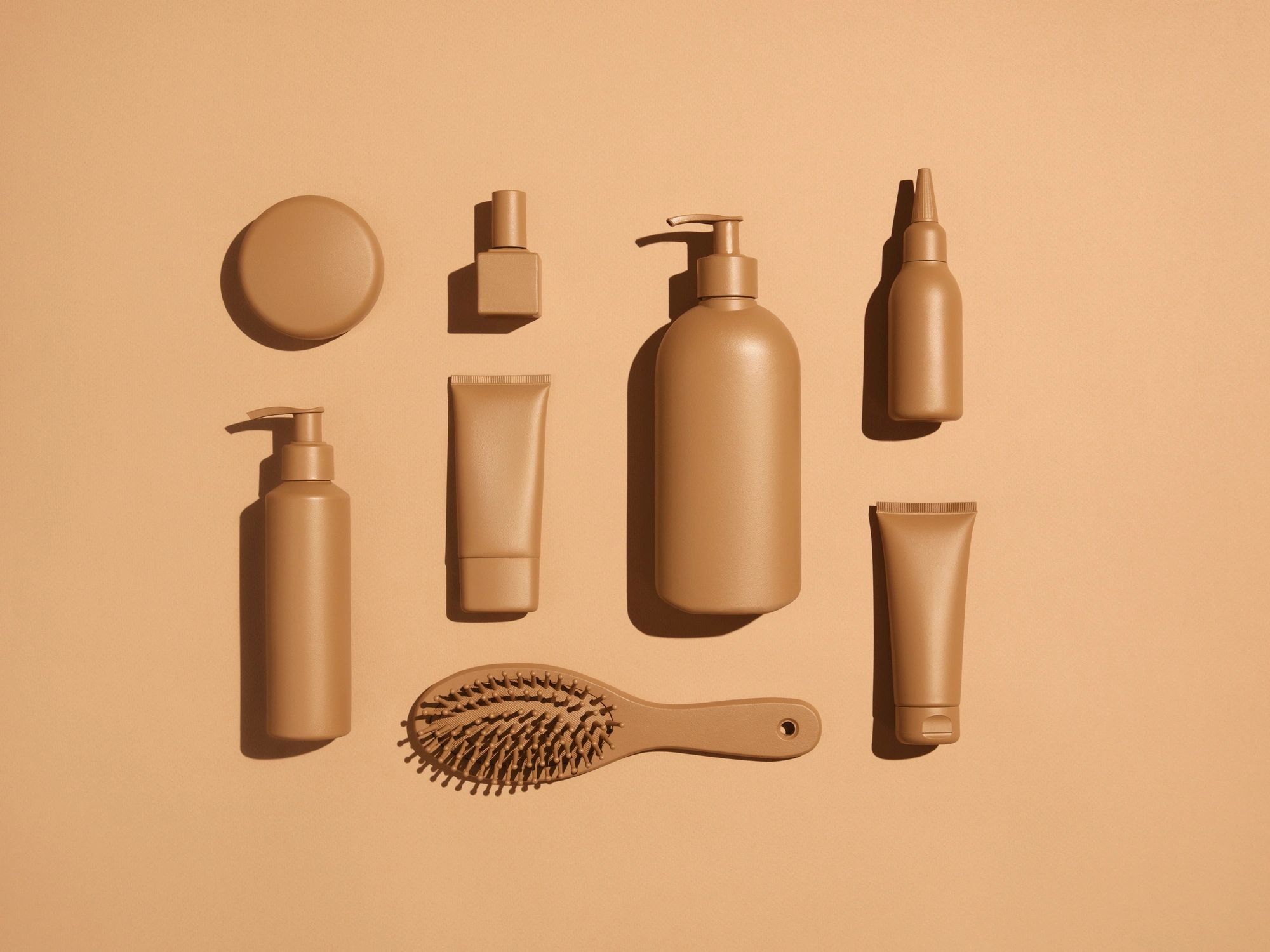 Curated beauty products arranged in soft beige tones