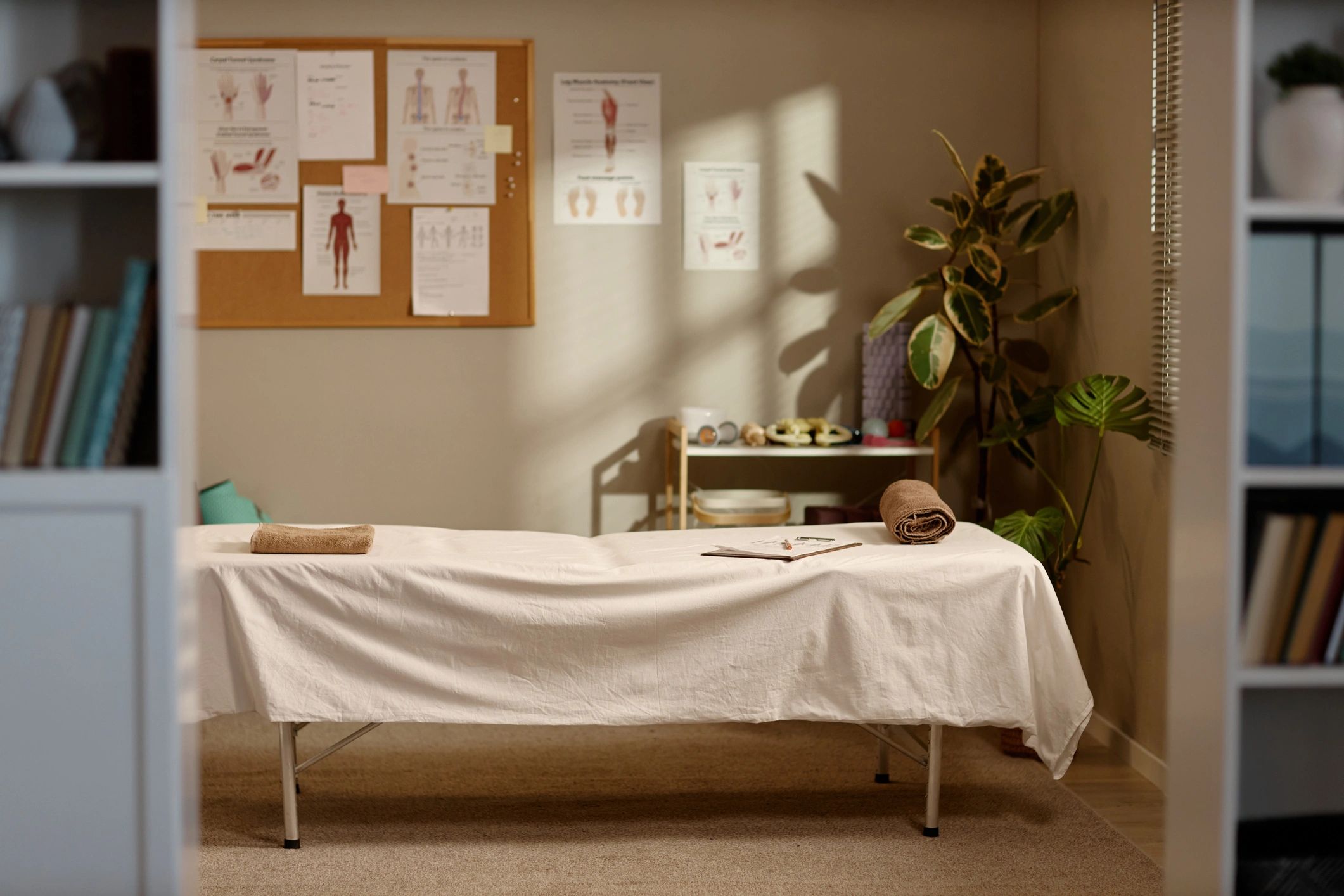 Massage treatment room with massage bed prepared for wellness care